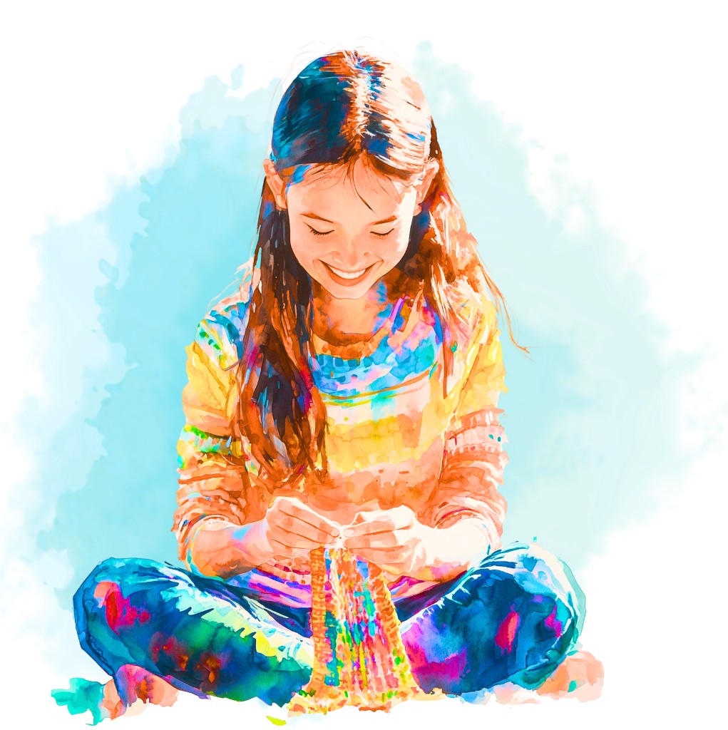 Student smiling while working on a colorful hands-on craft project